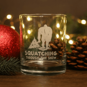 Squatching Through the Snow Bigfoot Christmas Glass | Sandblast Etched Drinkware | Sasquatch Holiday Gift | Bigfoot Dragging Christmas Tree | Funny Christmas Glass
